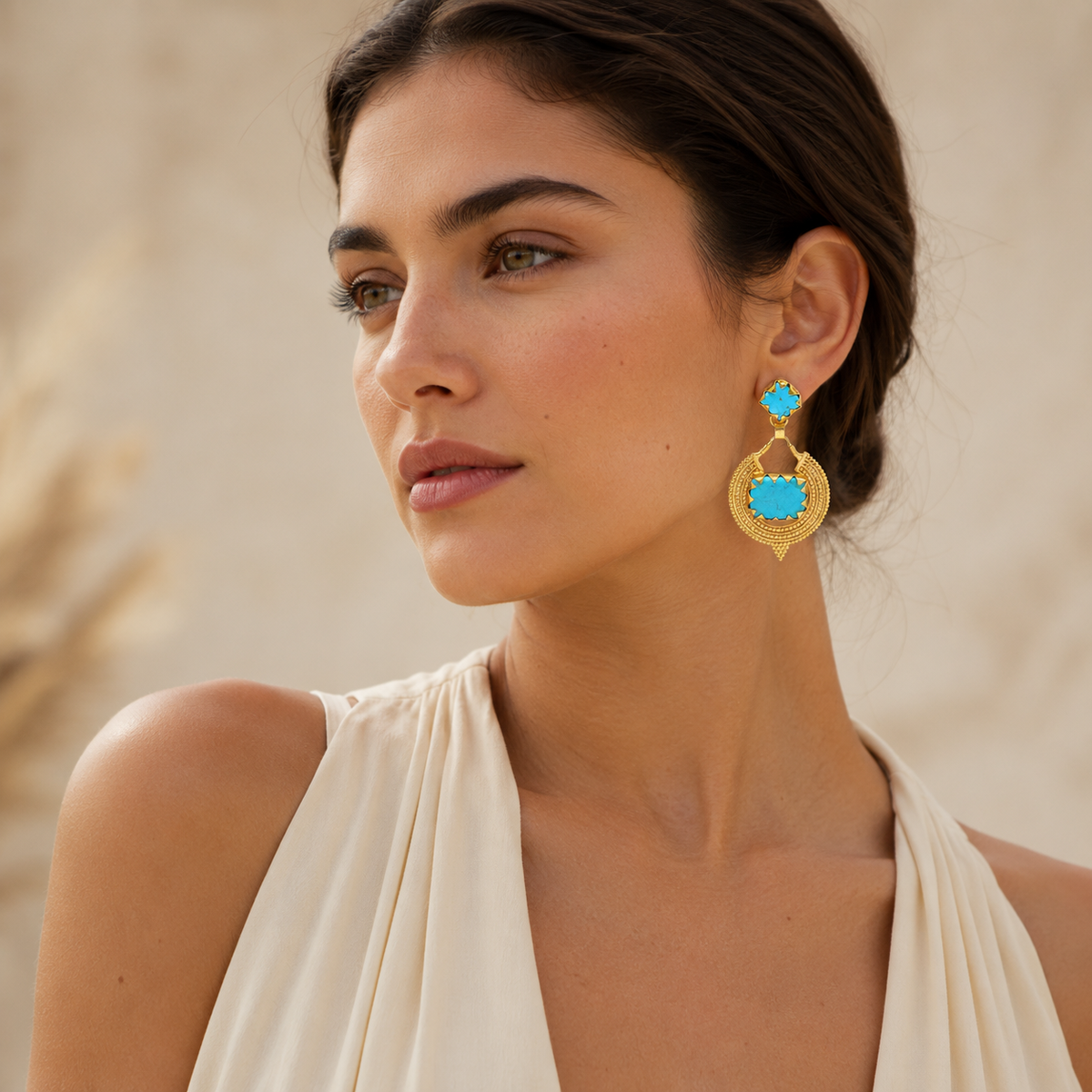 Turquoise and gold drop earrings with a bold geometric silhouette.