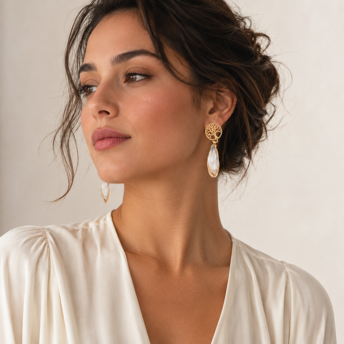 Tree of life earrings with a long clear stone drop.