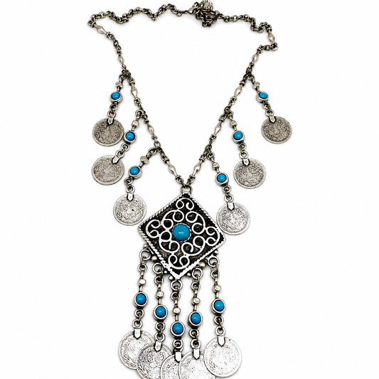 Silver necklace with turquoise accents, medallion coins, and a fringe pendant.