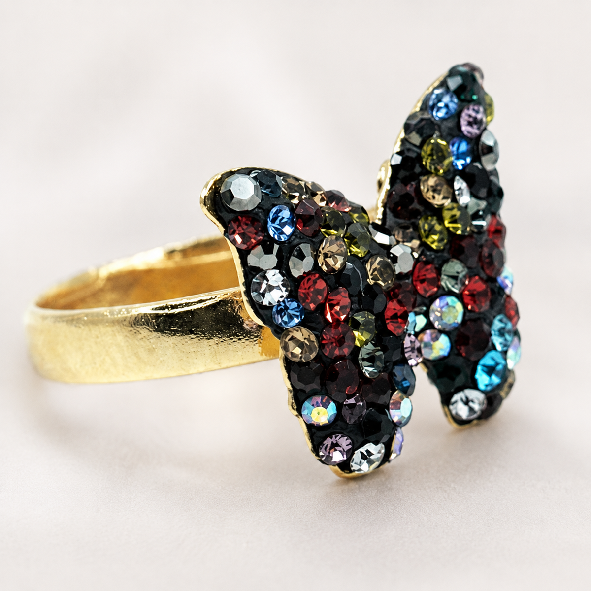 Close view of the butterfly ring with sparkling multicolor stones.