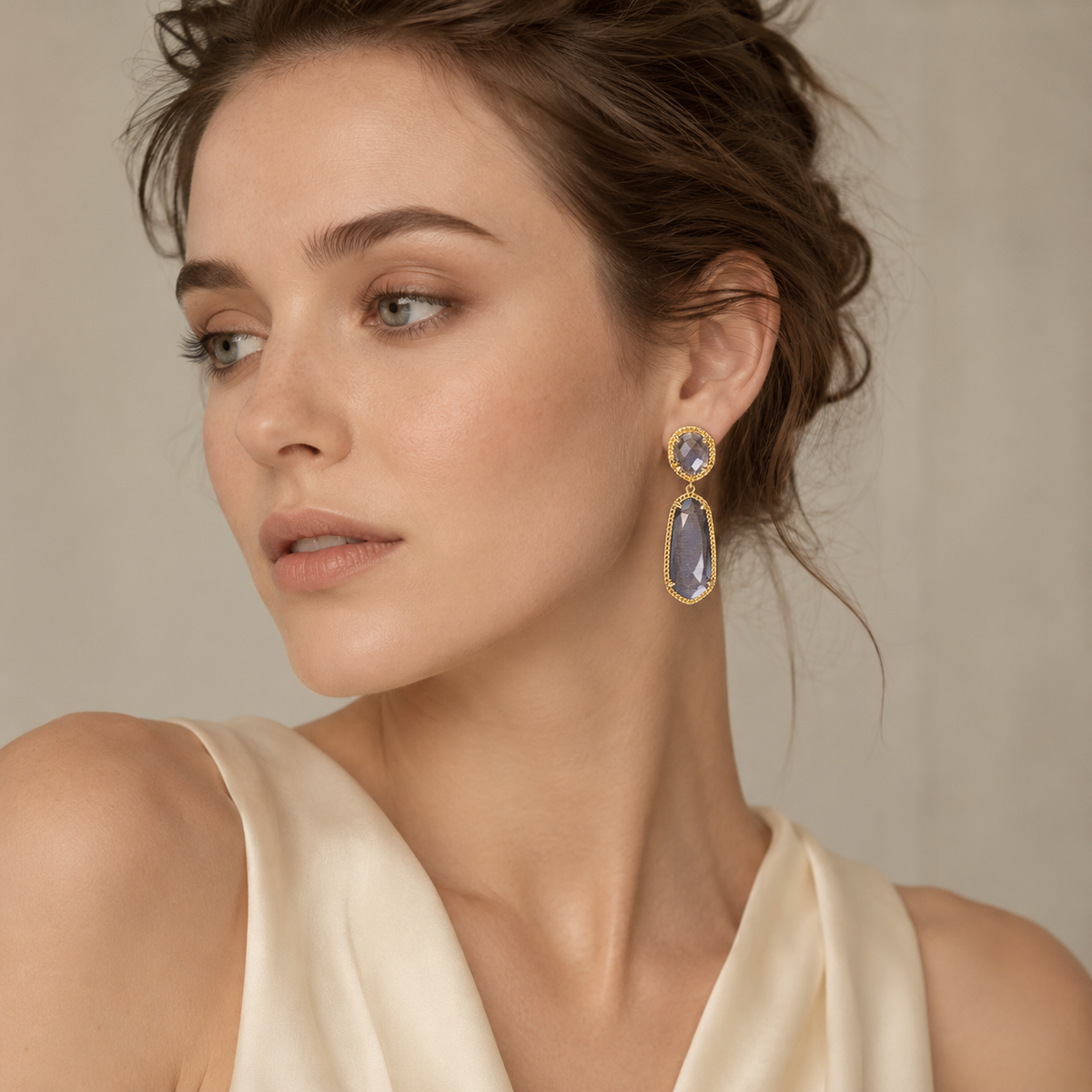 Statement drop earrings with smoky gray stones and gold-tone framing.