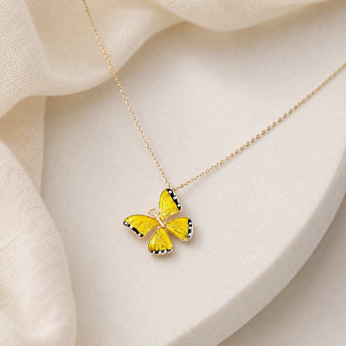 Yellow butterfly pendant necklace shown on a white background.