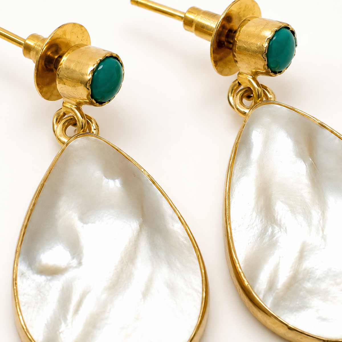 Close view of the mother of pearl drop and turquoise accent detail.