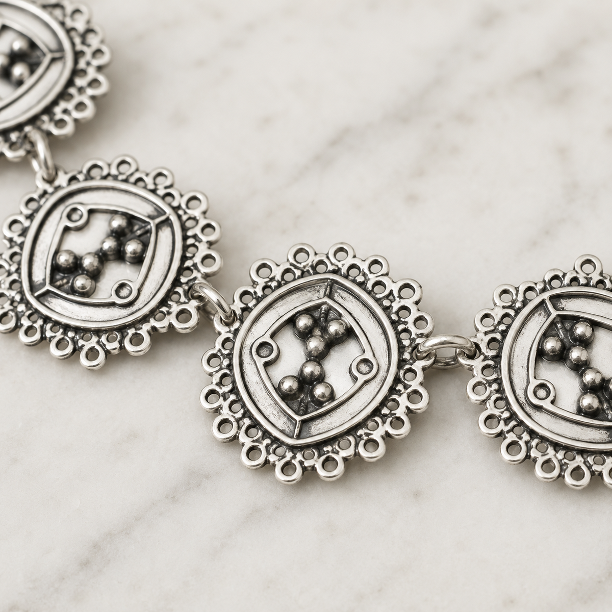 Close view of the necklace’s detailed cluster links and polished finish.