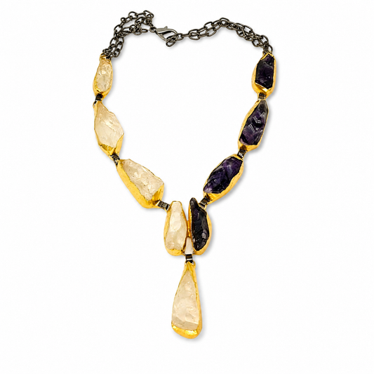 Y-shaped statement necklace with purple and crystal-like stones and gold-tone settings.