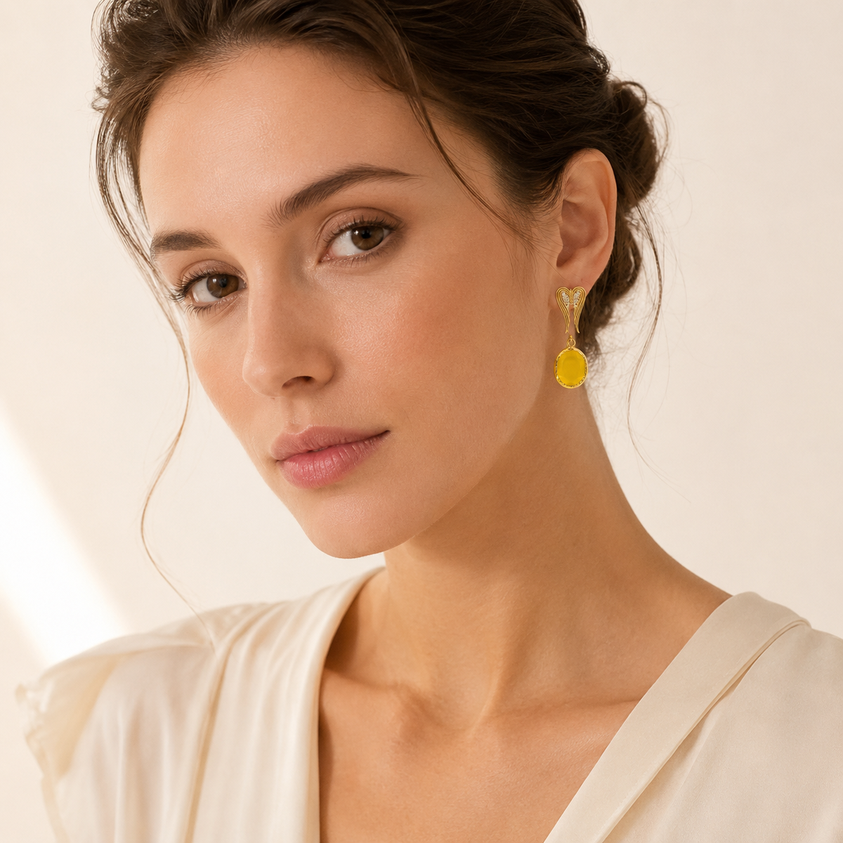 Gold-tone heart-shaped earrings with black crystal accents.