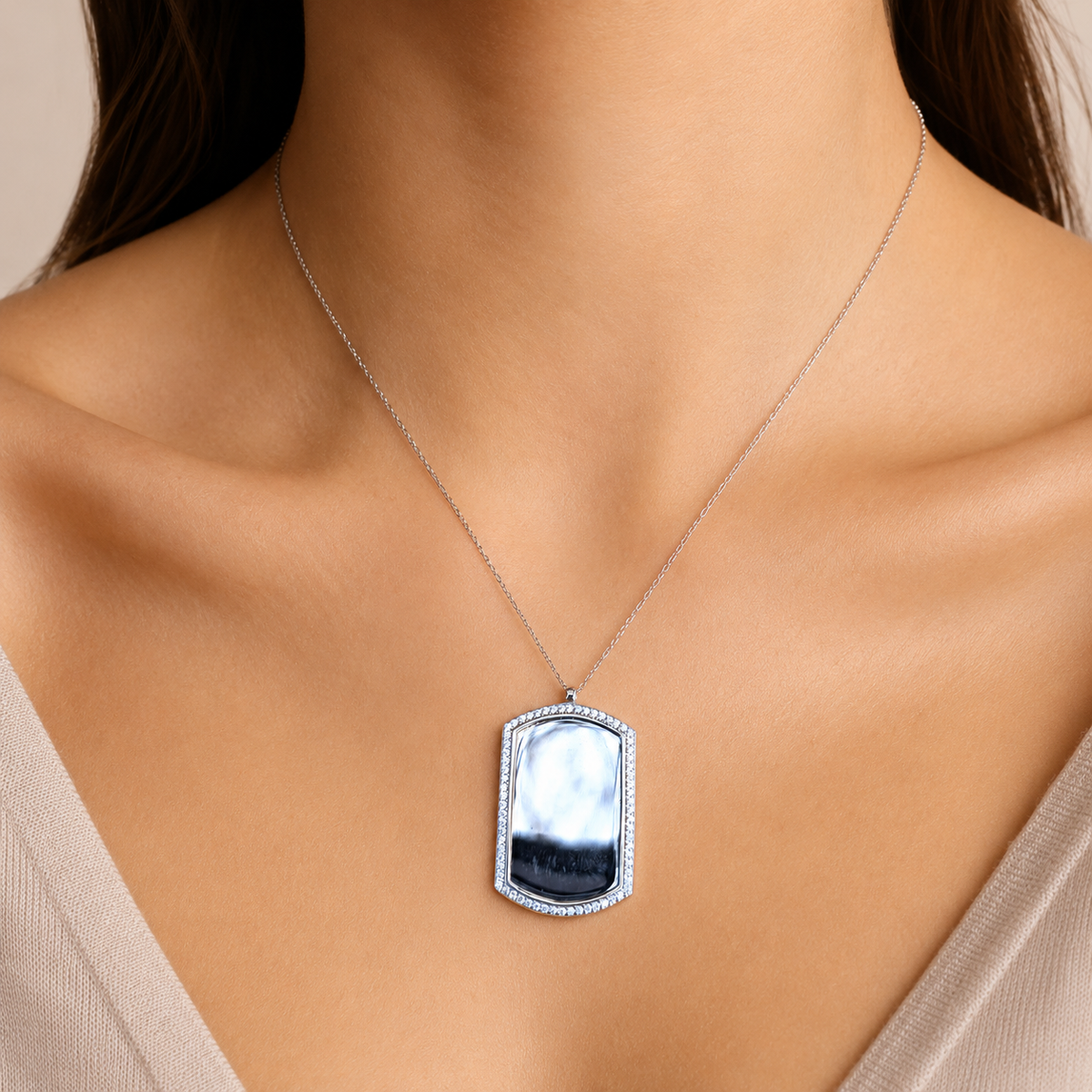 Dog tag necklace shown front view with a reflective center stone and sparkling border.