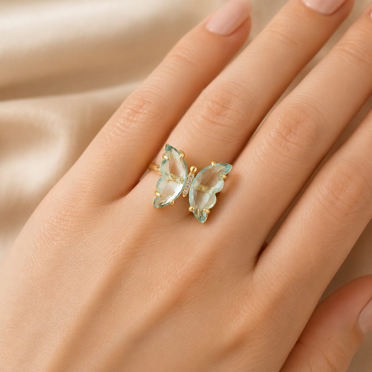 Gold-plated butterfly ring with sky blue topaz wings and CZ accents.
