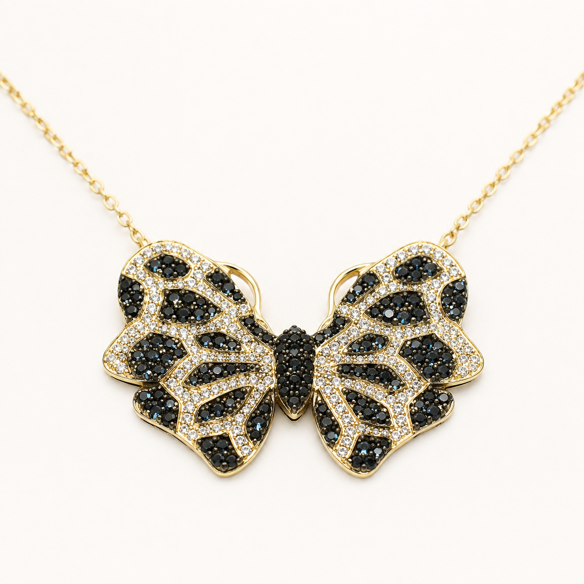 Close view of the butterfly pendant with dark textured detailing.