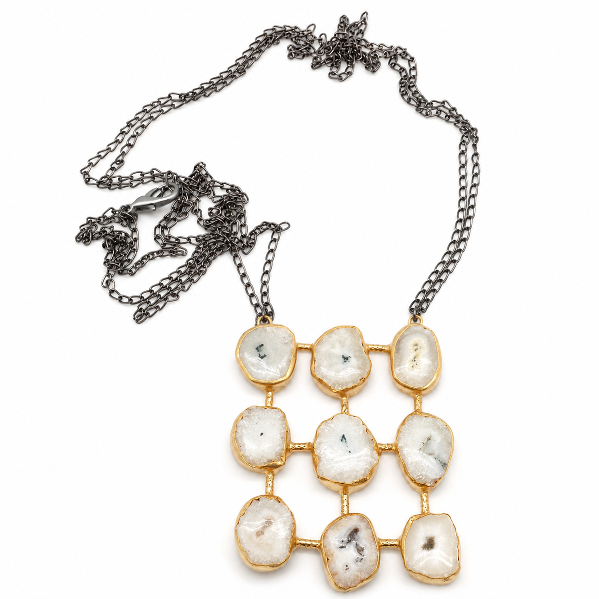 Quartz-like stone grid pendant necklace with a gold-tone frame and dark chain.