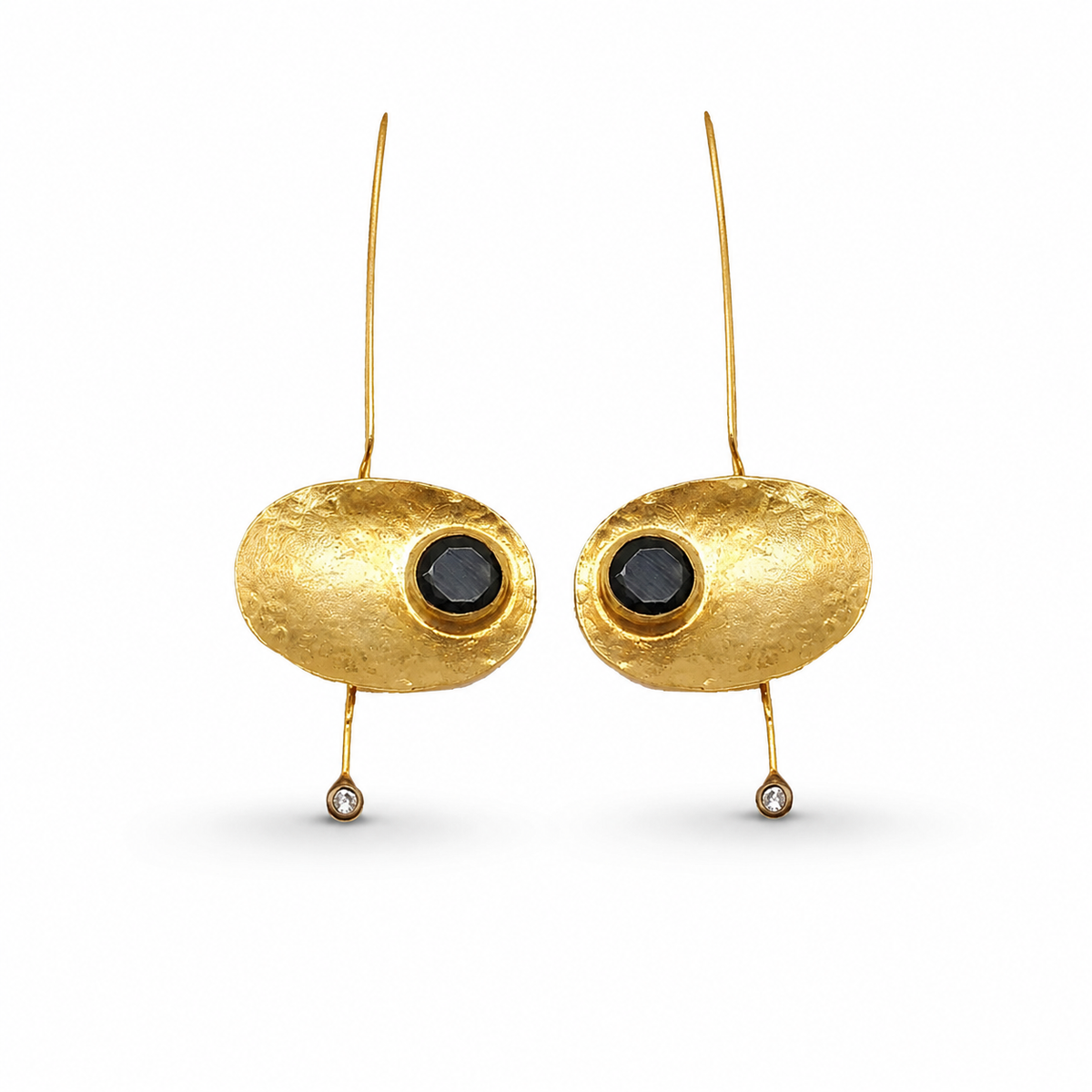 Oval gold-plated statement earrings with a black stone center and slender drop.