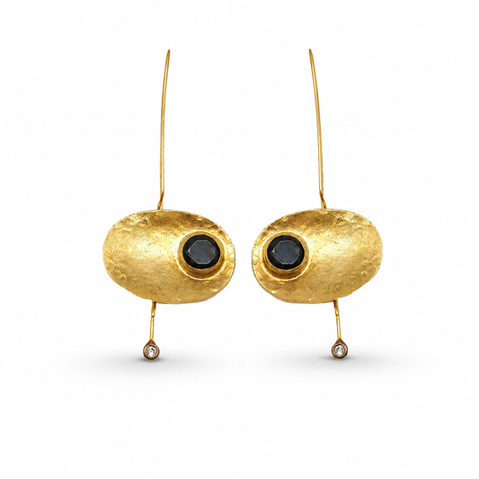 Oval gold-plated statement earrings with a black stone center and slender drop.