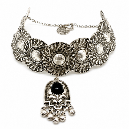 Silver-tone embossed disc choker necklace with a black stone pendant and dangling accents.