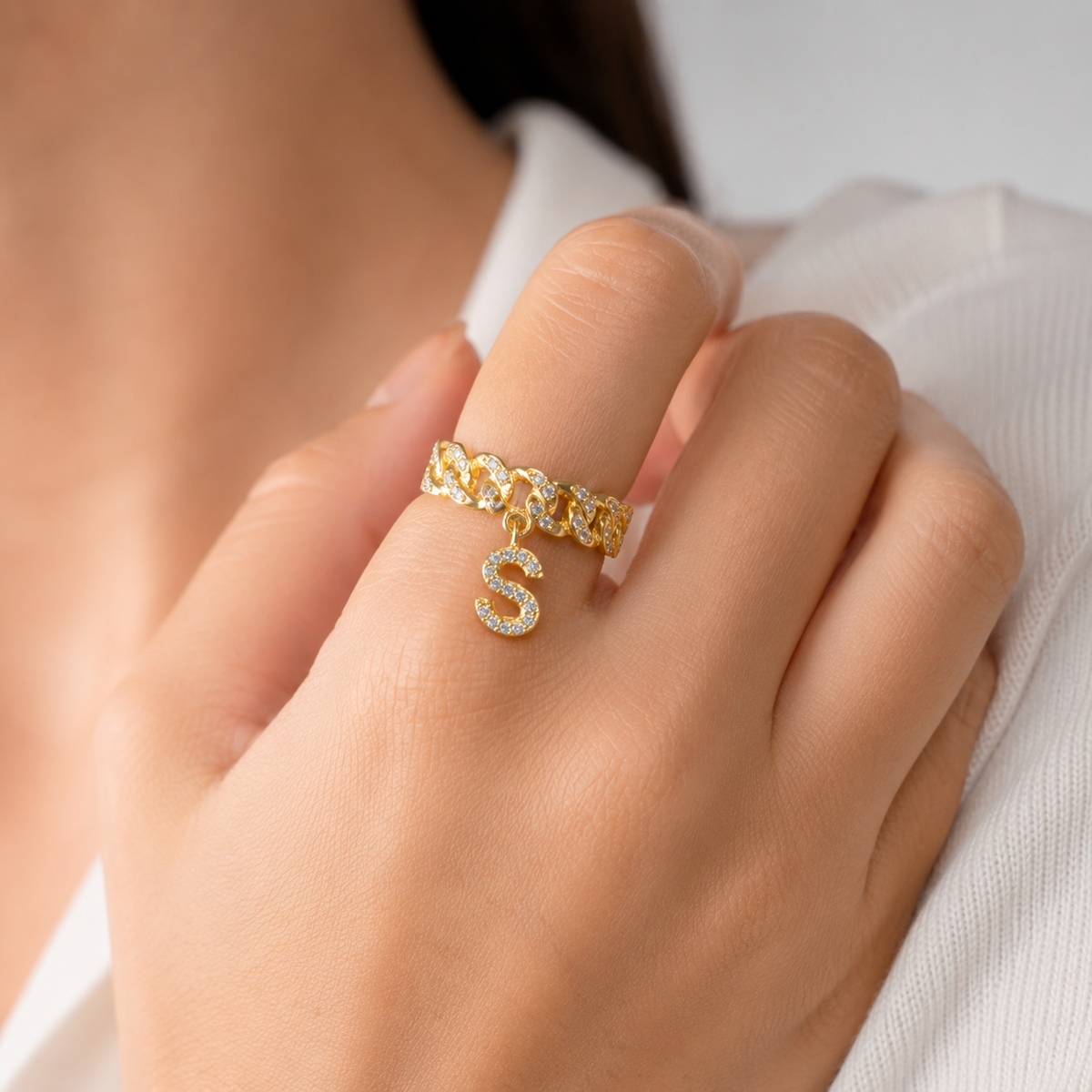Gold-tone personalized cuff ring with sparkling clear stones and an initial charm.