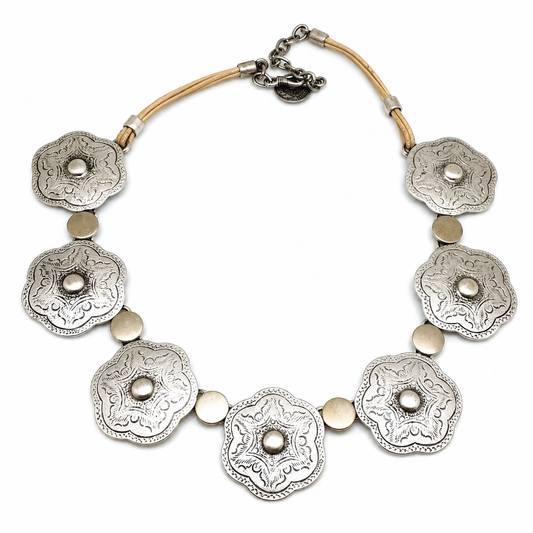 Silver-tone necklace with floral engraved plate pendants arranged along the chain.