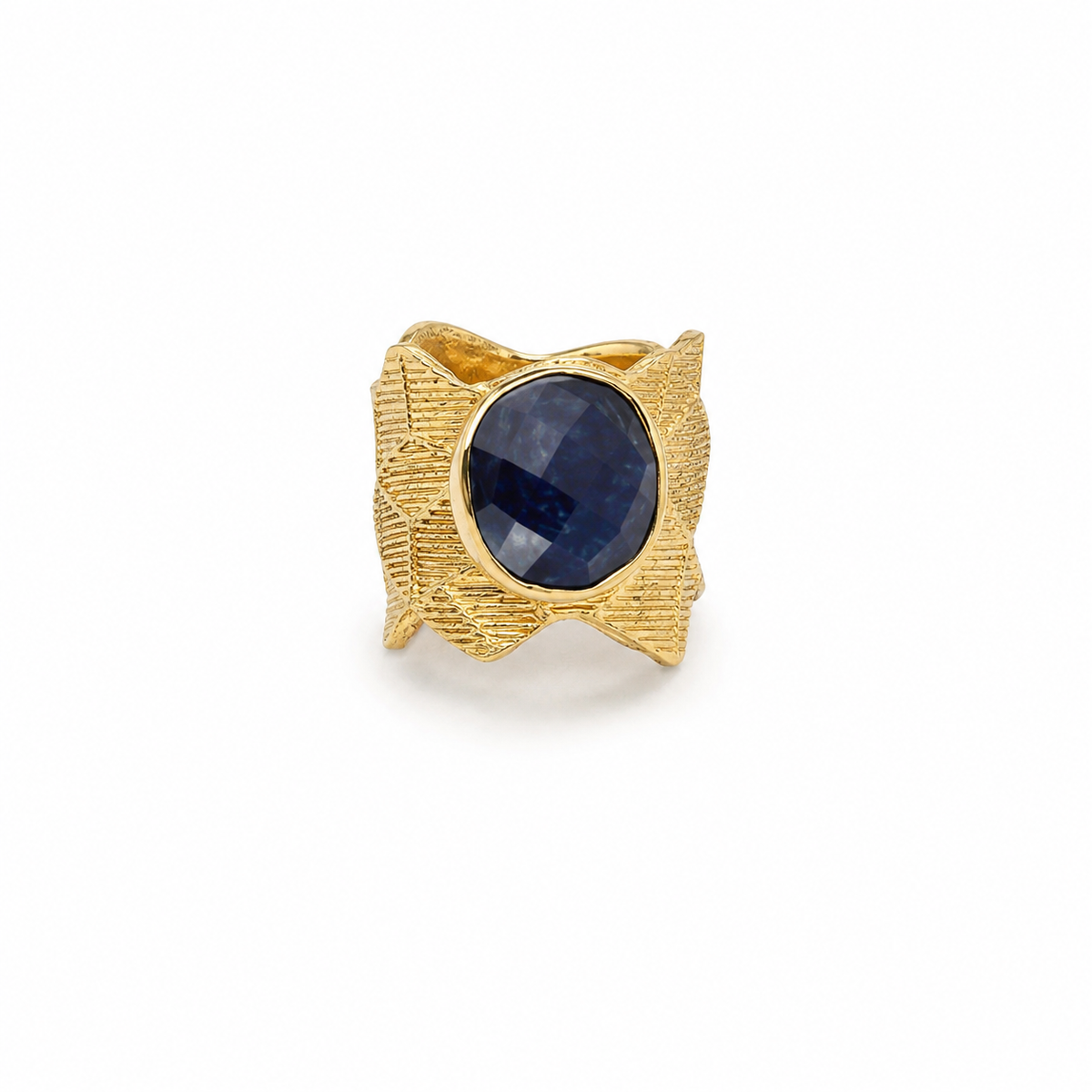 Gold-plated ring with a faceted navy blue oval center stone and textured geometric setting.