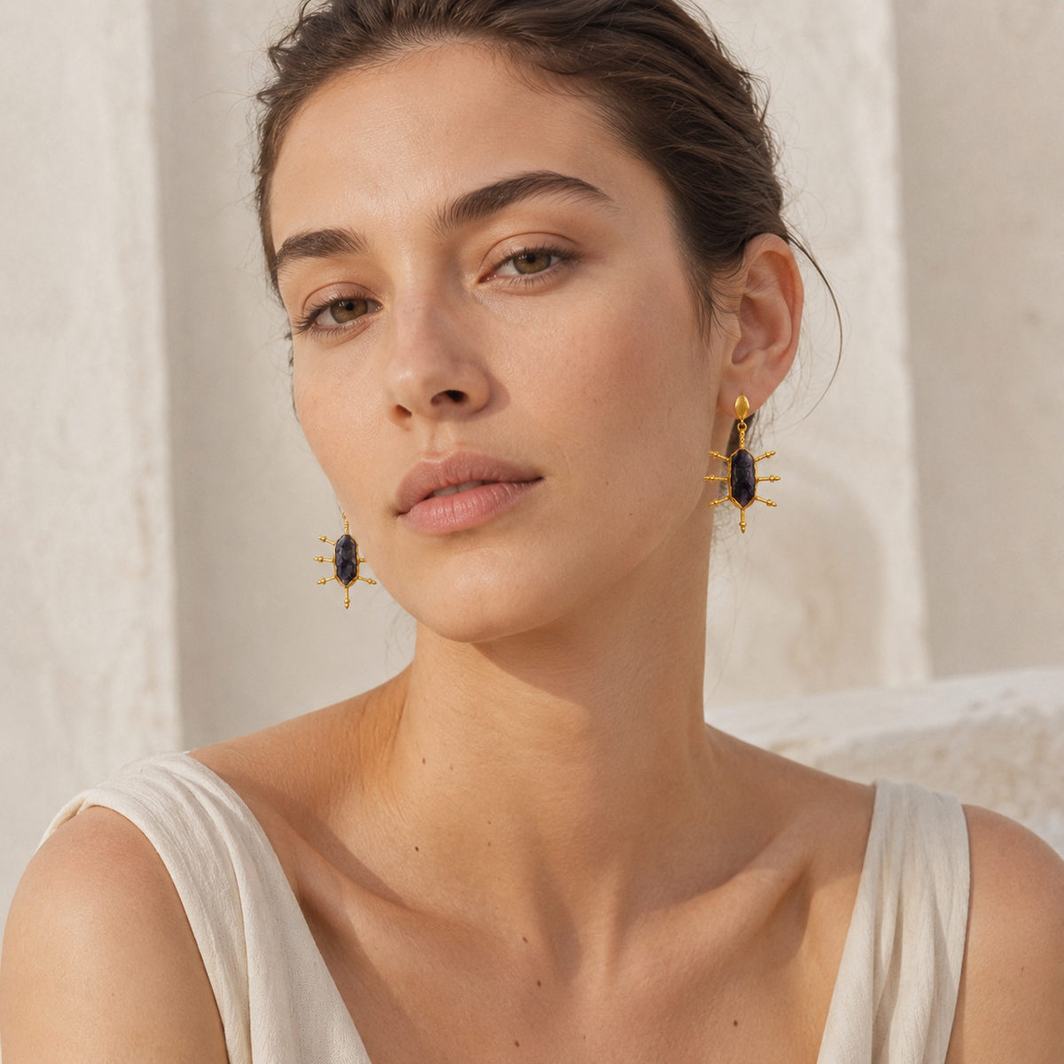 Raw amethyst drop earrings with a bold gold-plated design.