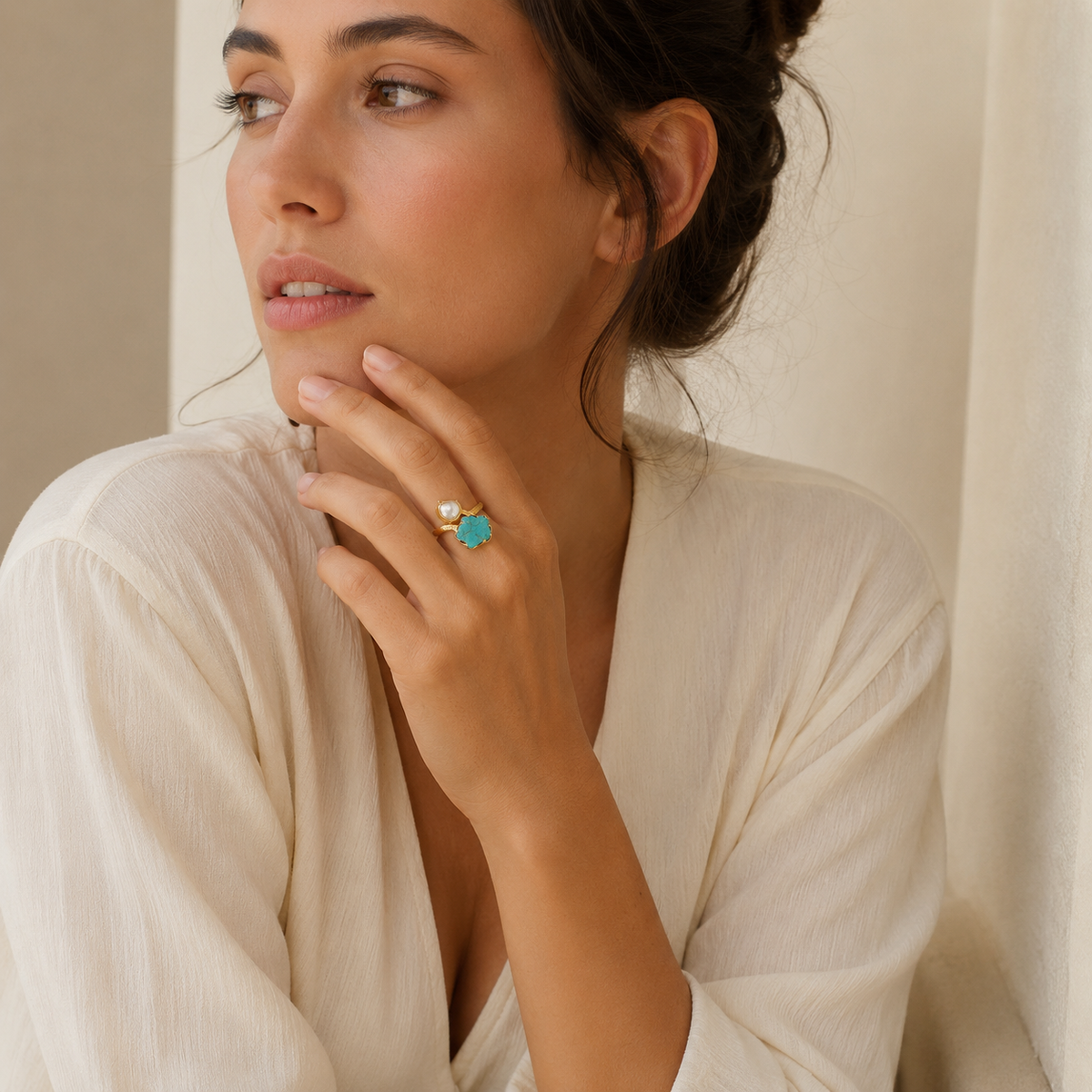 Two-stone gold-plated ring with turquoise and pearl-like accents.