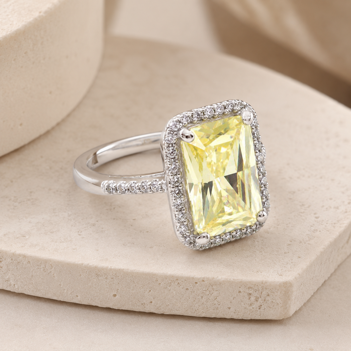 An angled view of the canary yellow ring showing the faceted stone and band.