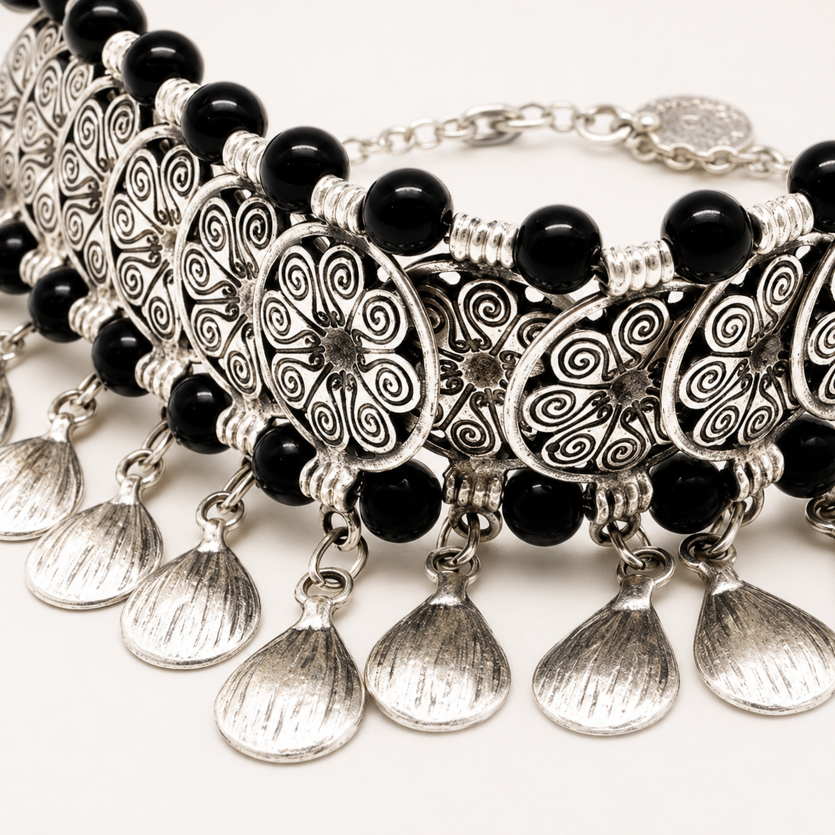 Close view of black beads and silver-tone fan details.