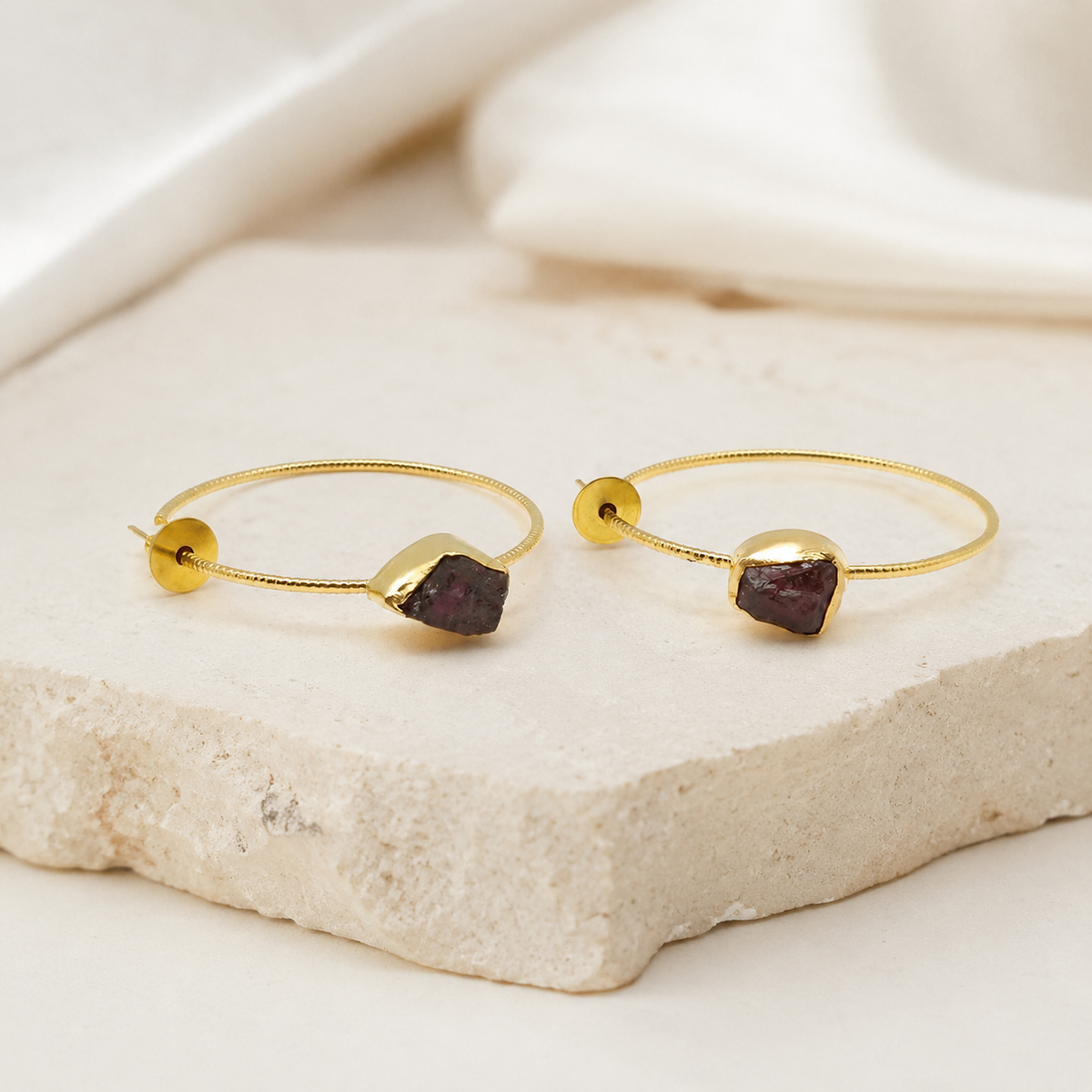 Gold-plated drop earrings with green agate slice stones styled on a clean background.