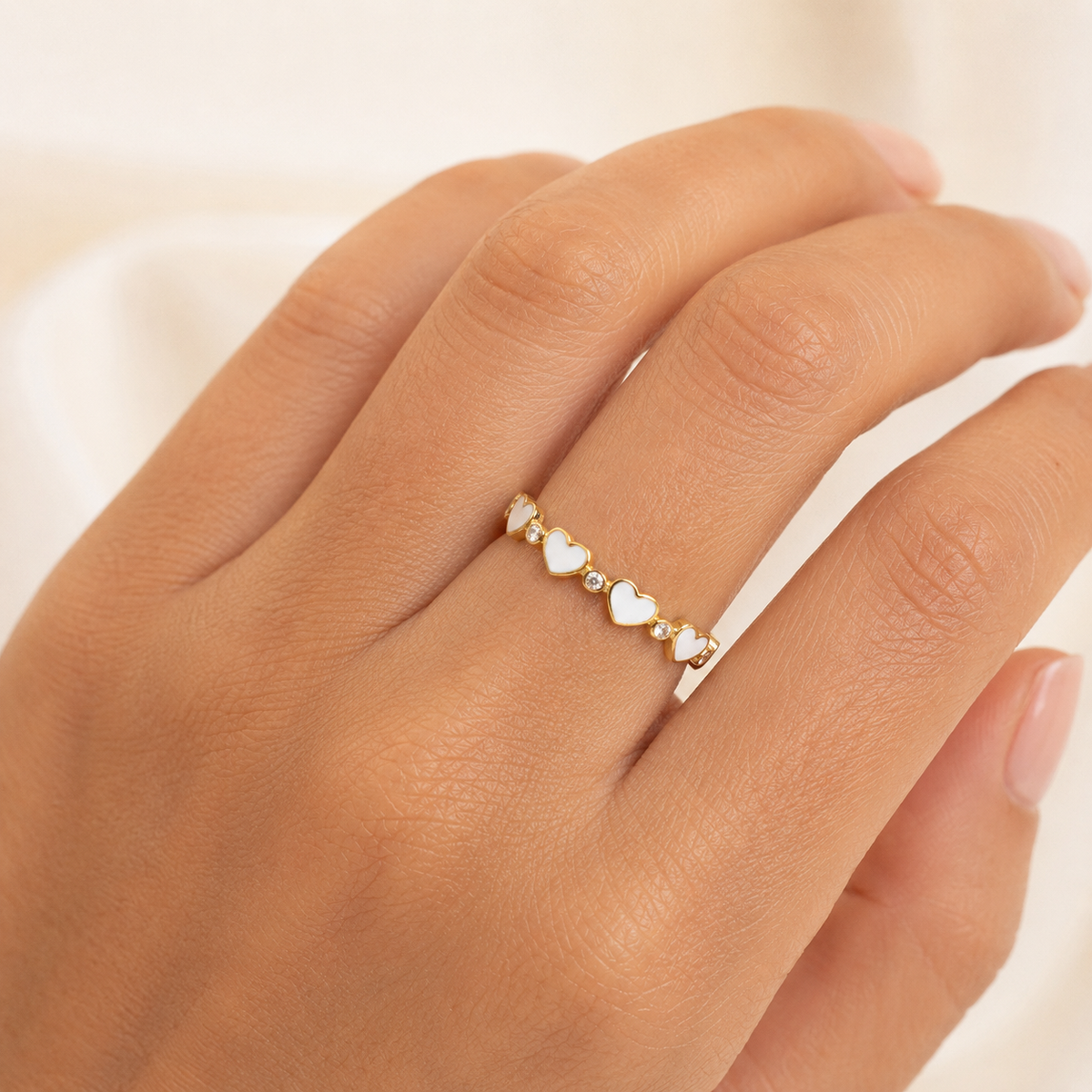 Gold-plated heart ring shown on a white background.