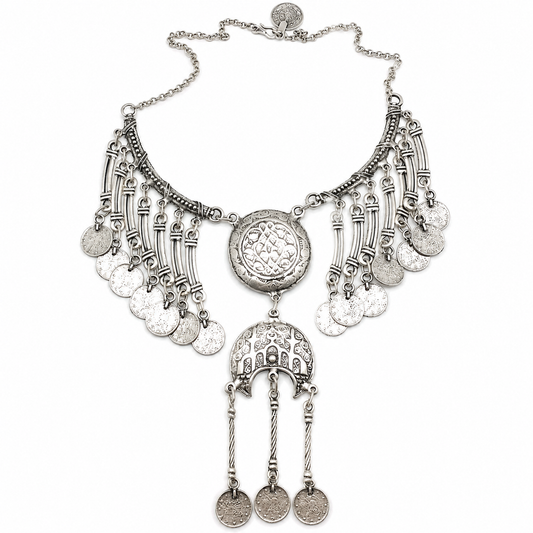 Silver-tone crescent coin fringe statement necklace with etched medallion details.