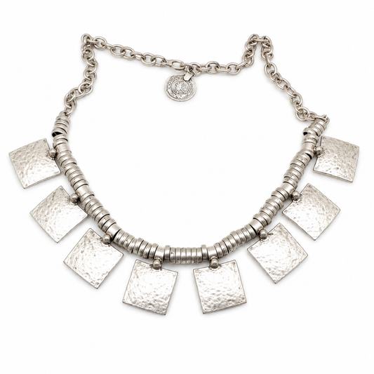 Hammered square charm necklace in a silver-tone finish with textured square pendants.