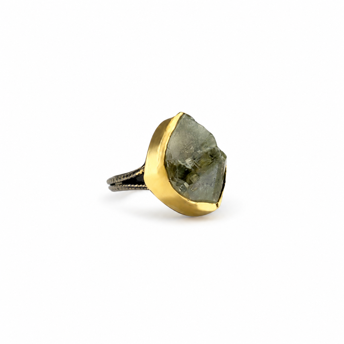 Raw green amethyst statement ring with a gold-plated setting on a white background.